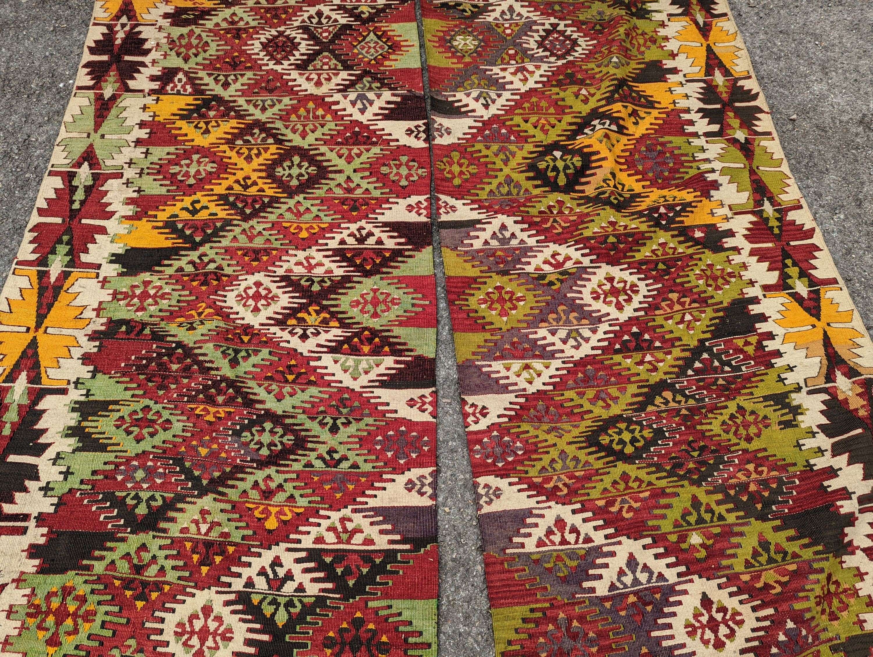 A Kelim polychrome flatweave carpet, cut centrally to create a pair of runners, each 410 x 85cm